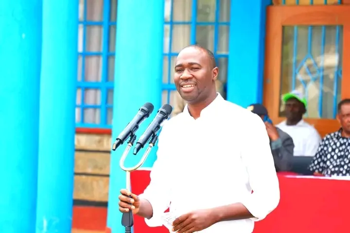Manyatta MP Gitonga Mukunji speaking at podium in white shirt during past event