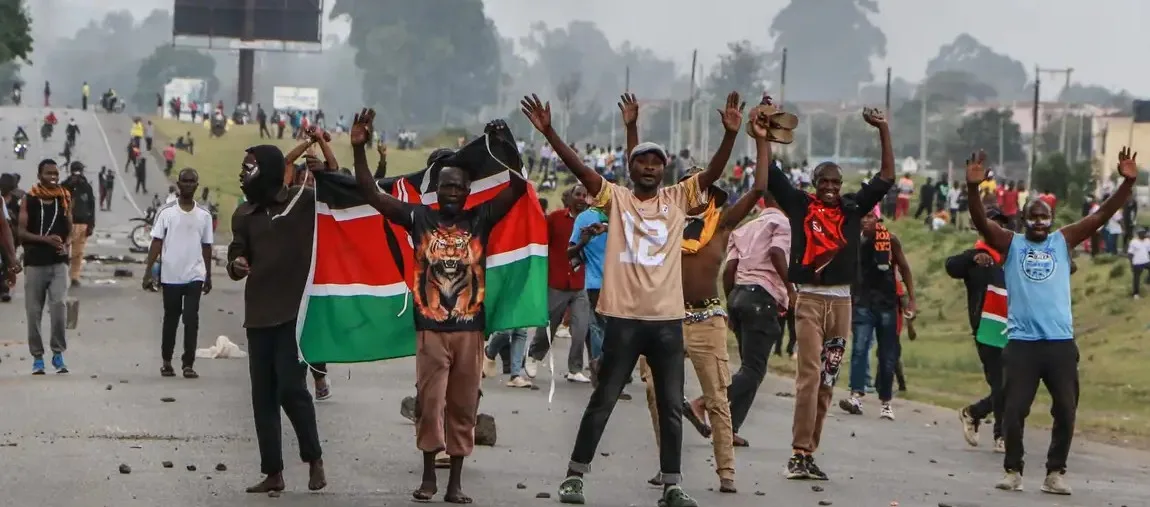 Kenyan youth holding national flag during street protest chanting Ruto Must Go