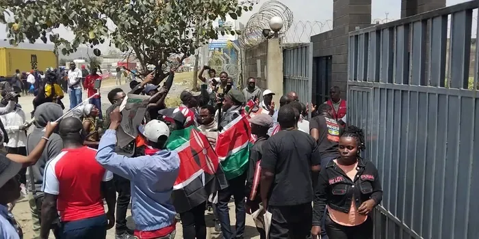 Crowd of protesters and activists with Kenyan flags clashing outside Standard Group gate on Mombasa Road Nairobi on Oct 2 2026