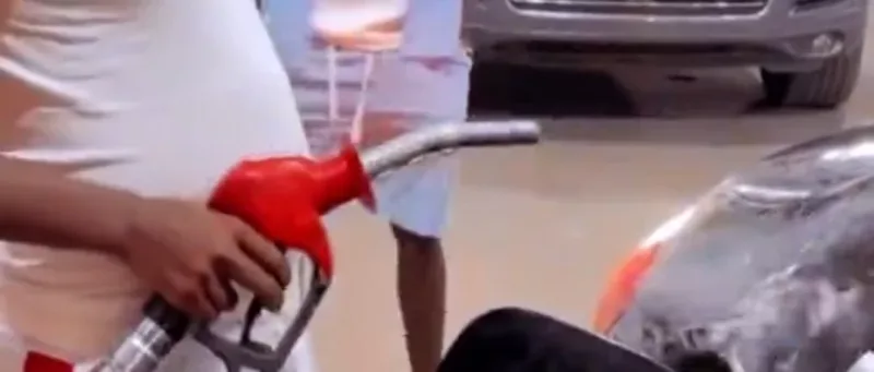 Man washing wheels with petroleum.